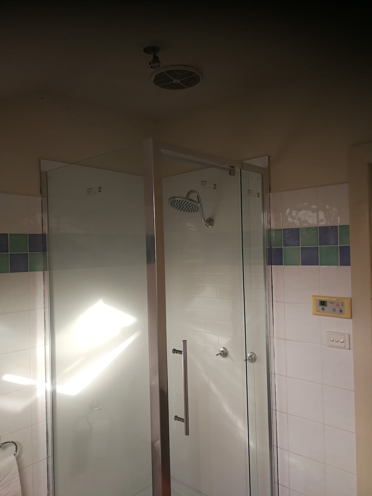 Bathroom with a frameless shower screen and rain shower head