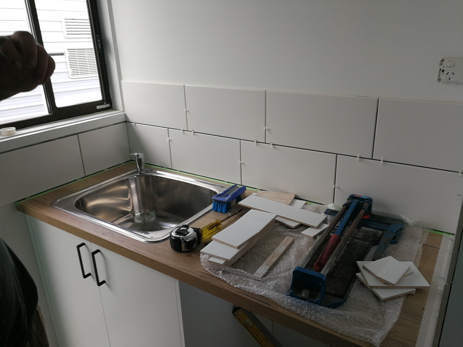 Laundry splashback tiling in progress