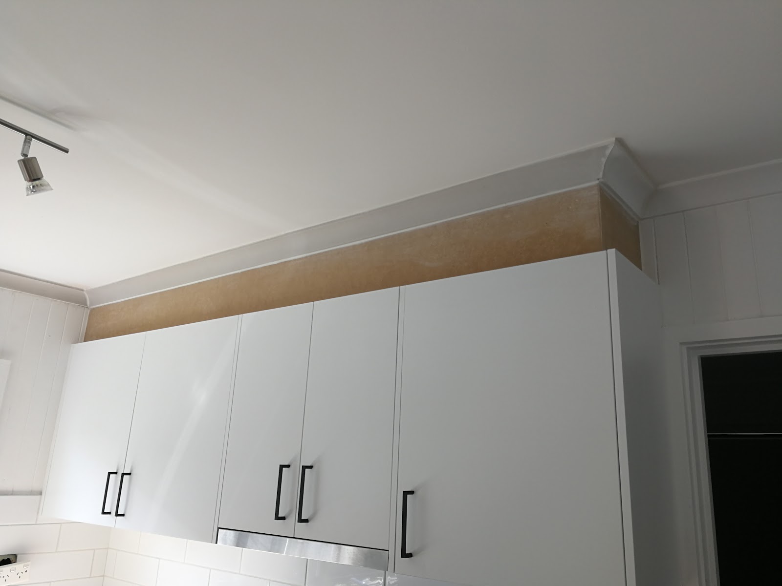 Overhead cupboards and cornice being fitted